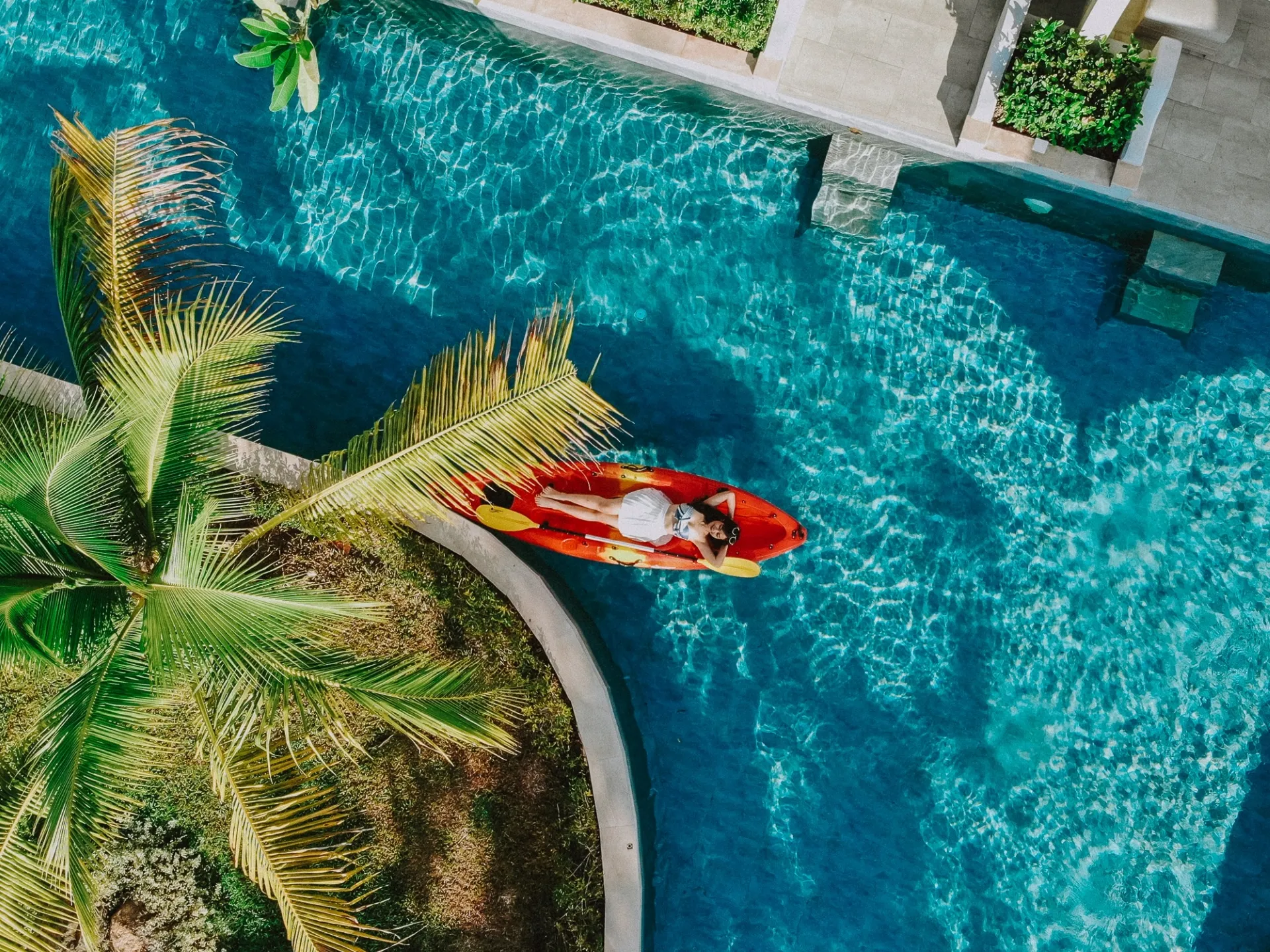 Girl laying on a boat in a swimming pool